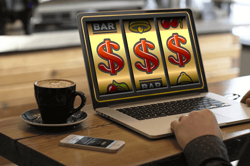 Real Money Slots Games - Photo of Man Playing Game on Laptop